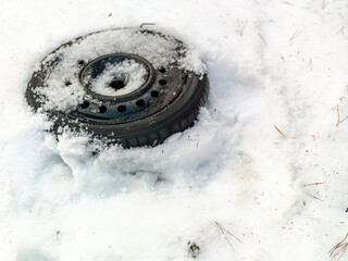 wheel abandoned in the snow