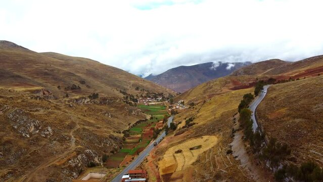 Aerial view of the breathtaking andean valley panorama with terraced fields. Winding roads. And
