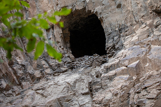 A hole in the bedrock wall resembles a cave. Ashabi-Kahf in Nakhchivan.