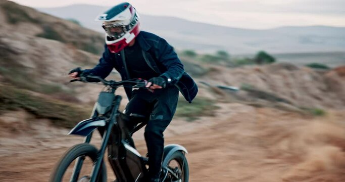 Person, motorbike and speed competition on dunes for extreme sports riding, challenge or adventure. Driver, electric bike and hill as professional performance with adrenaline stunt, path or dirt road