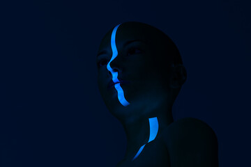 Woman face highlighted by blue light ray