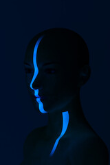 Woman face highlighted by blue light ray