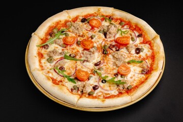 Scrumptious pizza with variety of toppings on a black background.