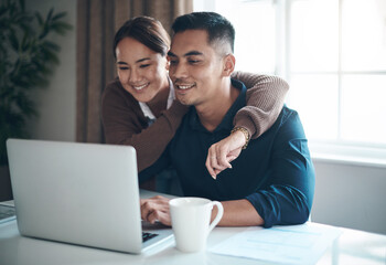 Couple, laptop and happy with budgeting in kitchen for savings, investment and mortgage payment with hug. Finance, people and technology with smile for debt review, insurance policy or tax documents