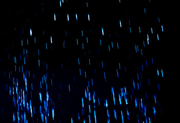 Drops of blue rain on a black background