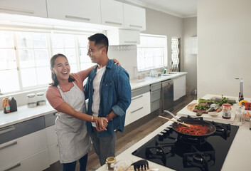 Dancing, cooking and couple in kitchen together with healthy food, relationship and bonding in...