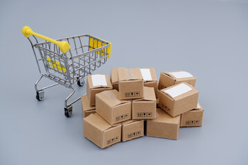 Purchase, delivery and shopping concept. Shopping cart and many carton boxes.