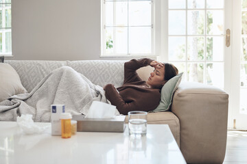 Woman, sick and headache with medication on sofa for flu, cold or sinus in living room at home. Tired female person with illness, fever or influenza in fatigue or asleep on couch from paracetamol - obrazy, fototapety, plakaty