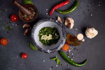 stone mortar with green sauce chopped ingredients