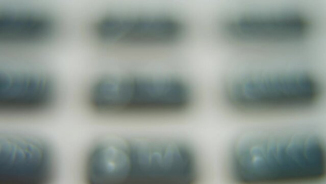 A macro close up shot of a pin pad numbers and letters on colorful buttons, tilt up movement, 4K video, depth of field