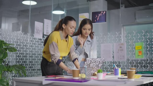 Indian Asian sad teen girls staff office room use laptop read online check job email shock news fail results feel bad upset young adult lady team have loss data issue error lost task deal look screen