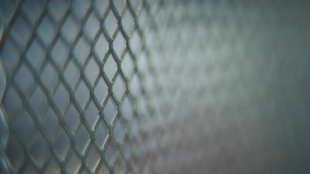 A hyper macro shot of a metal grid, steel pattern, iron industrial texture, aluminum material, super slow motion, Full HD 120 fps, tilt up movement