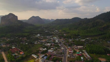Secondary road between limestone rocks at sunset in Krabi, Thailand. Aerial view