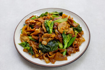 Stir-fried rice noodles with soy sauce and pork