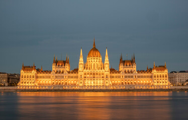 Fototapeta na wymiar Incredible front view on Parliament building in Budapest with fantastic perfect sky and reflection in water. calm Danube river. Popular Travel destinations. creative image used as background.