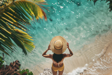 Summer vacation and holiday concept. Rear view of woman in sunhat overlooking clear turquoise ocean. - Powered by Adobe