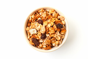 Muesli oat cereals with raisins, dried fruits and sunflower seeds in bowl on white background. Top...