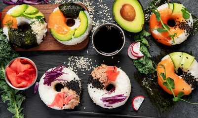 Sushi donuts on a dark background. Hybrid trend food.