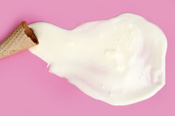 Melting ice cream balls with waffle cone on pink background.