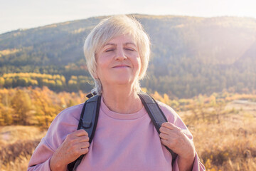 Middle aged woman hiking and going camping in autumn forest