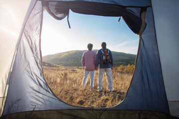 Camping tent vacation and adult couple man and woman enjoying freedom at forest - 781102984
