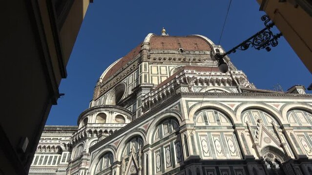 Florence, Italy, seen from below. Details of the cathedral and Giotto's bell tower. View of the Basilica of Santa Maria del Fiore. 4K footage