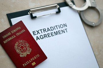 Passport of Italy and Extradition Agreement with handcuffs on table close up - obrazy, fototapety, plakaty
