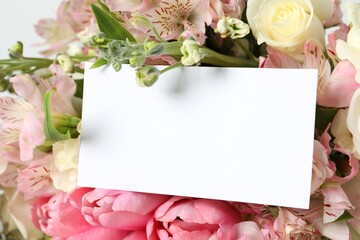 Obraz na płótnie Canvas Happy Mother's Day. Beautiful flowers with blank card on light background, closeup