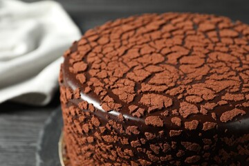 Delicious chocolate truffle cake on table, closeup