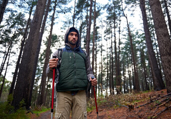 Hiking, backpack and man in forest for shelter, survival and dangerous conditions. Nature, winter...