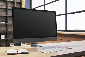 Close up of modern designer office workplace with empty computer monitor, window with city view and wooden shelves in the background. Mock up, 3D Rendering. - 781121175