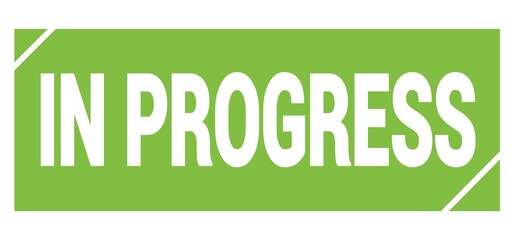IN PROGRESS text written on green stamp sign.