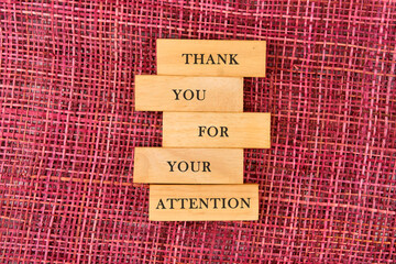 Thank you for your attention concept. Text written on wooden blocks on a mesh background