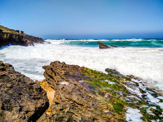 Coast of Portugal. One of the beaches in Cascais with crystal clear water. A great place for water sports - surfing.