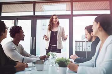 Woman, business and diversity in boardroom for meeting or presentation, manager or leader or collaboration. Female coach and colleagues in office for planning or teamwork, workshop with team or files