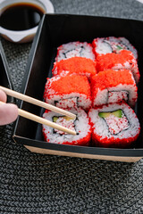 Takeaway Japanese food on paper boxes. Sushi in box lunches.