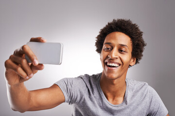 Selfie, smile and black man with connection, picture and social media on a white studio background....
