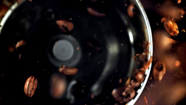 Super slow motion Coffee beans in a working grinder. High quality FullHD footage