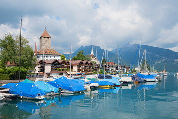 harbor tourist resort Spiez, lake Thunersee, with moored boats and castle view