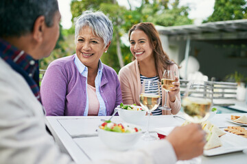 Mature mother, female daughter and smile with lunch on table and conversation with father for...