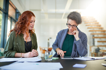 Tablet, teamwork or business women in startup for news, conversation or discussion in office...