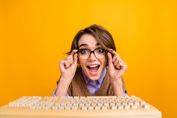 Photo portrait of attractive young woman keyboard amazed react web camera dressed retro office clothes isolated on yellow color background - obrazy, fototapety, plakaty