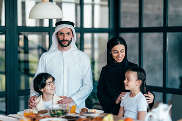 Fototapeta na wymiar Traditional arabian family from Dubai spending time together at home