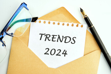 The evaluation methods, popular topics, and new trends in business. TRENDS 2024 written on a sheet...