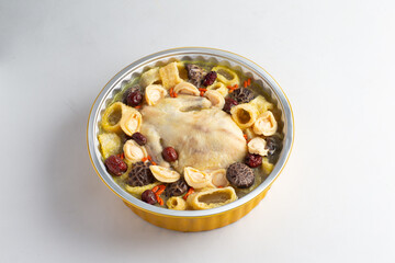 freshly hot stewed whole kampong chicken with abalone seafood in clay pot herbal soup on white table hotel chinese new year banquet restaurant halal food cafe menu