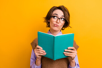 Photo of minded girl dressed knitwear waistcoat in glasses hold copybook look at offer empty space...