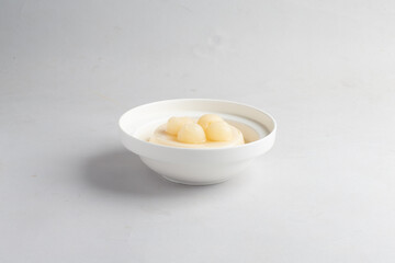 ice cold cute milk almond soya bean curd pudding jelly on plate with longan lychee fruit decor on...