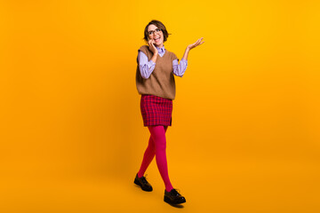 Photo portrait of attractive young woman walk talk phone dressed retro office clothes isolated on yellow color background