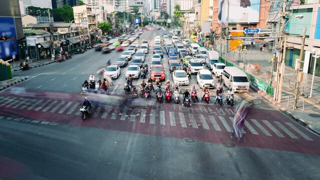 Traffic of Asok intersection in Bangkok, Thailand in timelapse. Thai text on crosswalk means If you stop the car on the crosswalk you will be fined.
