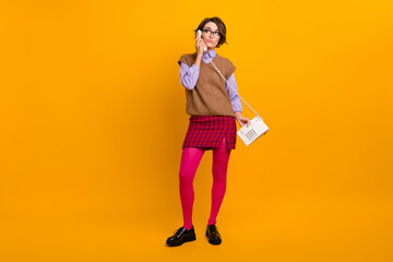 Photo portrait of attractive young woman moody look empty space phone call dressed retro office clothes isolated on yellow color background